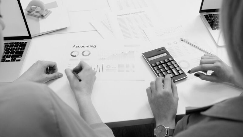 Accounting desk with calculator and reports at an Auckland firm