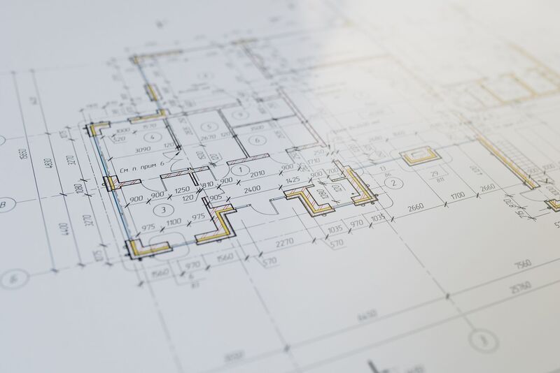 Architect reviewing blueprint plans for an Auckland design project