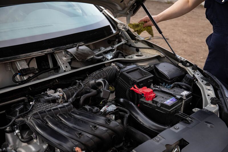 Auckland auto repair mechanic working under a vehicle in a workshop