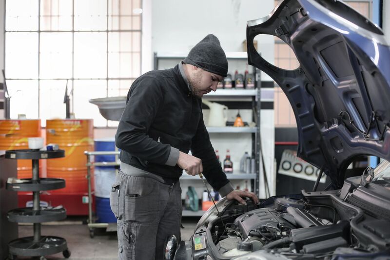 Mechanic diagnosing a car engine in an Auckland auto repair shop