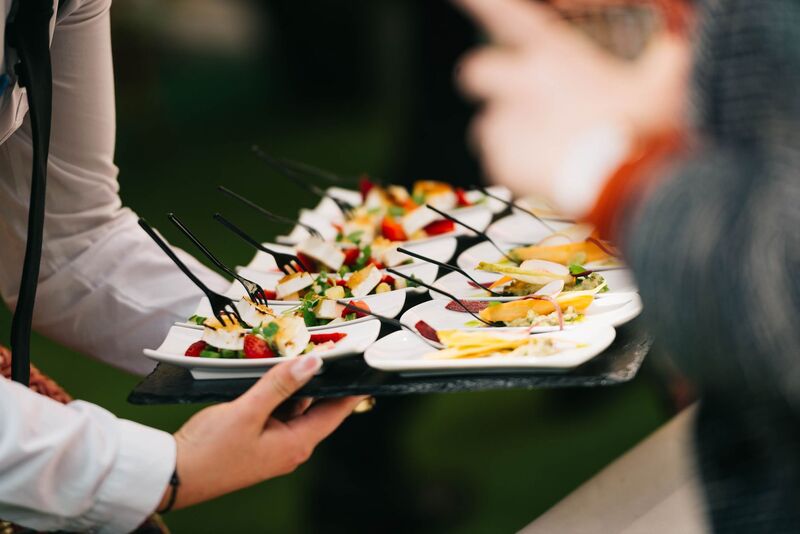 Catering company plating gourmet food for an Auckland event
