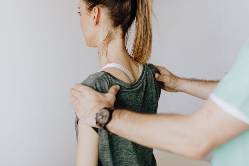 Chiropractor discussing a back care plan with a patient in Auckland