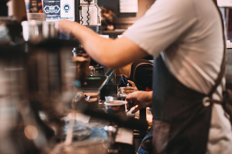 Auckland café interior with customers enjoying coffee across a competitive local market