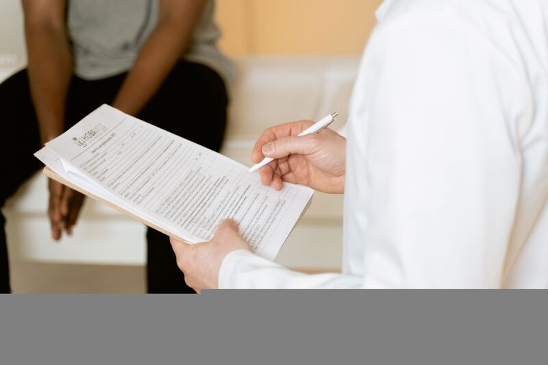 GP reviewing a patient's medical consultation notes in Auckland