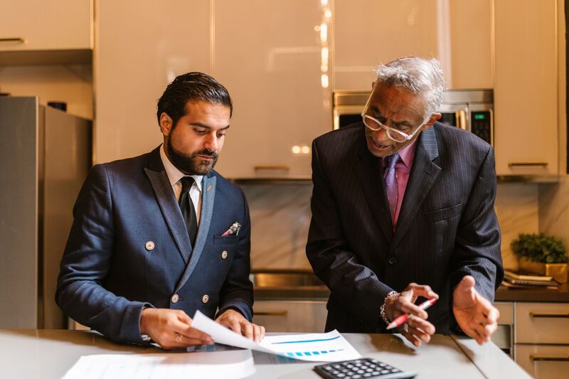 Auckland financial adviser reviewing retirement planning content and reports with a client