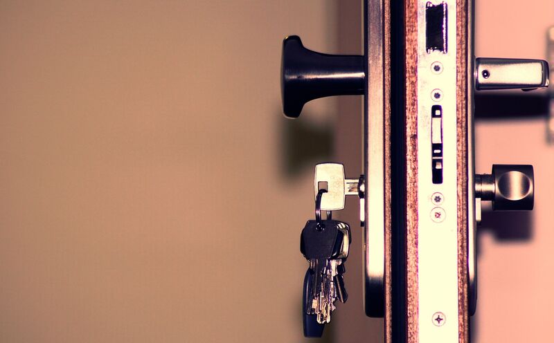 Locksmith fitting a door lock for an Auckland home security job