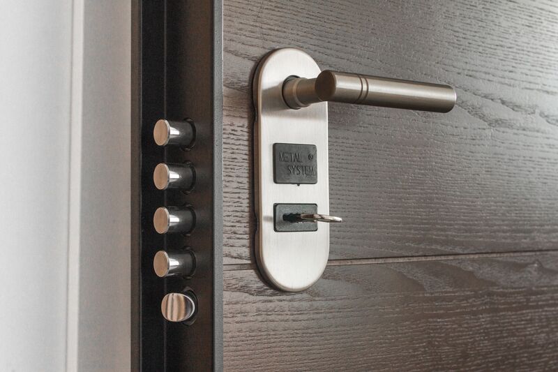 Hand inserting a key into a residential door lock in Auckland