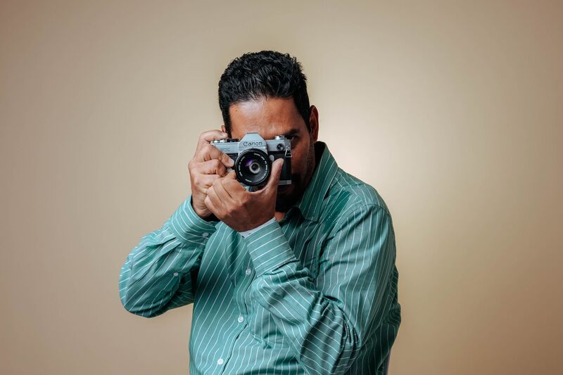 Professional photographer with camera on an Auckland shoot