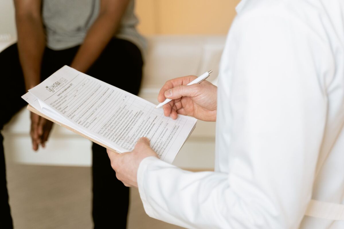 Plastic surgeon consulting with a patient at an Auckland cosmetic clinic