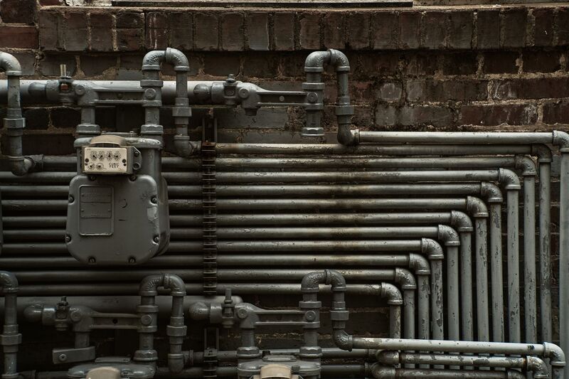 Close-up of plumbing pipe connections during an Auckland repair