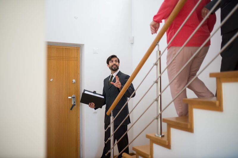 Real estate agent meeting Auckland home sellers about a property listing
