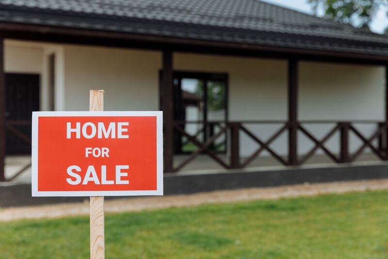 House for sale in an Auckland suburb with a sold real estate sign