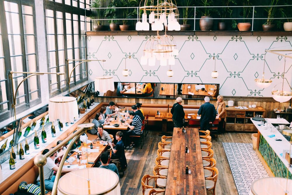 Busy Auckland restaurant interior with diners at candlelit tables