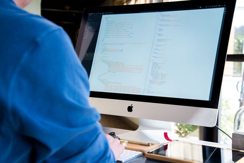 Software developer working at a screen for an Auckland software development company