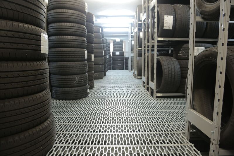 Tyre shop wall of new tyres ready for fitting in Auckland