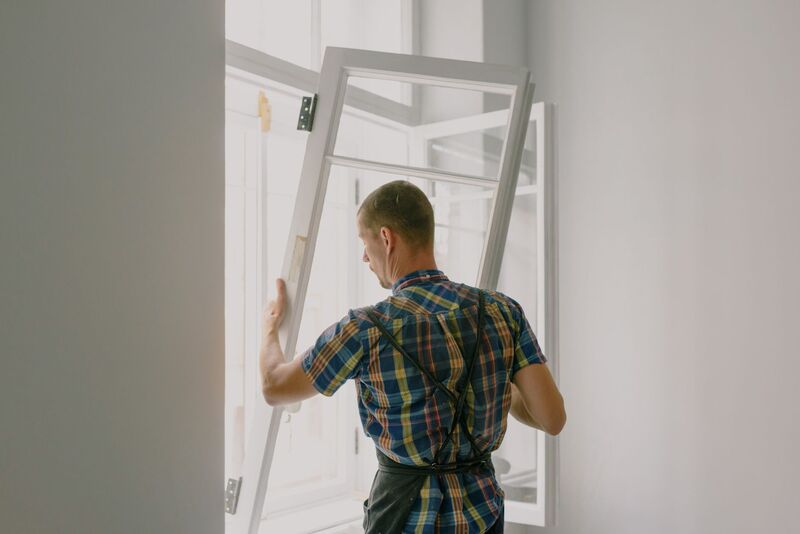 Installer fitting new double glazing windows on an Auckland home